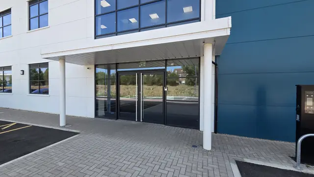 Main entrance with a canopy and glazed double doors in the office wing of the warehouse unit